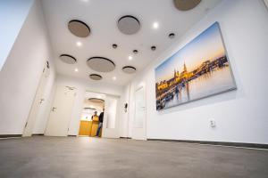 a hallway with a large painting on a wall at Sportpension Dresden in Dresden