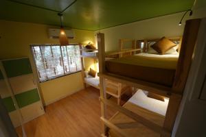 a room with two bunk beds and a window at Zen Colive in Pune