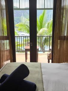 a bedroom with a bed and a view of a balcony at Exotic Trove in Eden Island +53 photos