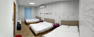 a room with two beds and two tables in it at 那瑪夏Lu-Mah民宿 in Min-tsu