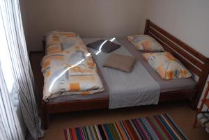 a bedroom with a bed with two pillows at Apartment on Knyahyni Ol'hy Street in Rivne