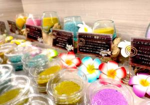a table with many different colored ingrediants in glass bowls at Hotel BaliBali 岩槻 in Saitama