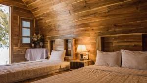 a bedroom with a bed and a wooden wall at Trại Mít Farm in Sóc Sơn