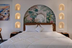 a bedroom with a large white bed and a tapestry at Larissa Resort in Nashik
