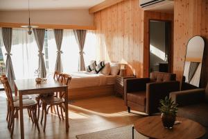 a living room with a bed and a table at Campgrounds at Mantalongon in Dalaguete