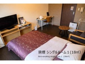 a hotel room with a bed and a television at Comfort stay Miyabi in Chichibu
