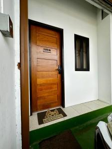 a door with a dog on a mat in front of it at Caishen Apartelle The Traveler Accomodation in Biga
