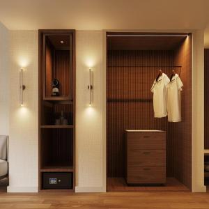 a bedroom with a closet with a dresser at Tivoli Coimbra Hotel in Coimbra