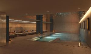 a lobby with a swimming pool in a building at Tivoli Coimbra Hotel in Coimbra