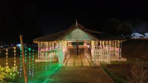 a gazebo decorated with christmas lights at night at Natures Nest Araku Resort in Araku
