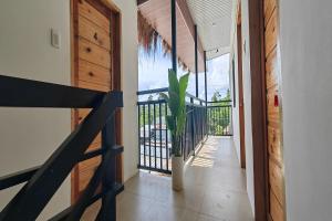 a hallway with a door and a plant in a vase at Eva's Guest House in General Luna