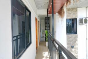 a hallway of a house with a balcony at Eva's Guest House in General Luna
