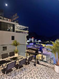 a balcony with a table and chairs on a building at A Luc House in Cat Ba