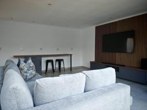 a living room with a white couch and a table at Kubata Diame B&B in Cape Town