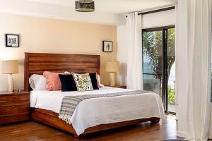 a bedroom with a bed and a large window at Lauloa 106 in Wailuku