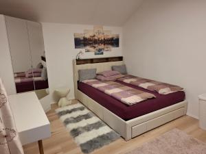 a bedroom with a bed and a mirror at Sterisches Daham in Aflenz Kurort