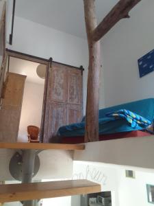 a shelf with a mirror and a wooden door at atypical house garden in Saint-Paulet-de-Caisson