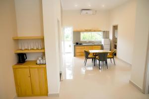 a kitchen and dining room with a table and chairs at Lotus Luxury Residencies in Negombo