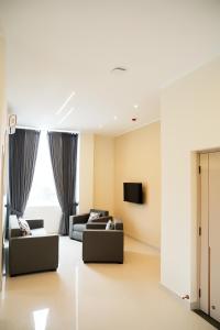 a living room with two couches and a tv at Lotus Luxury Residencies in Negombo