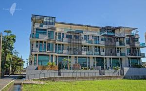 a large apartment building with balconies on a street at Migo Homestay in Yilan City
