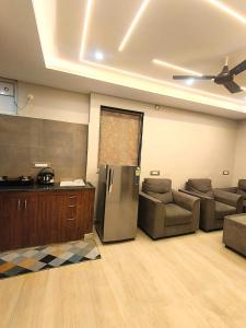a living room with a couch and a refrigerator at Mio Boutique Hotel - Just Launched in Hyderabad