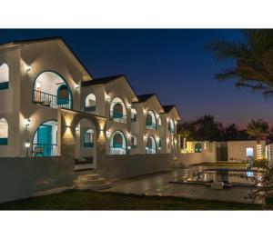 a large building with lights on it at night at Larissa Resort in Nashik
