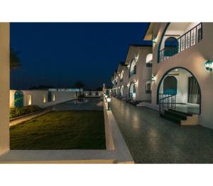 a night view of a courtyard of a building at Larissa Resort in Nashik +10 photos
