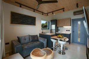 a living room with a couch and a table at Avithos Blue Villas in Svoronata