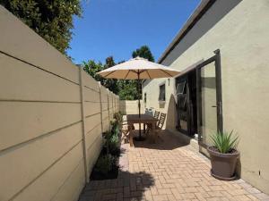 a patio with a table and an umbrella at The Hidden Gem in Oakdale
