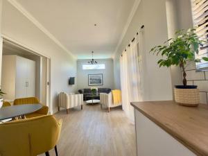 a living room with a table and yellow chairs at The Hidden Gem in Oakdale