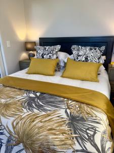 a bedroom with a large bed with yellow pillows at The Hidden Gem in Oakdale