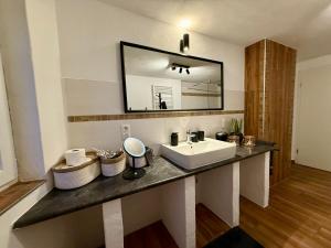 a bathroom with a sink and a mirror at Ferienhaus Griede mit 3 Schlafzimmern in Mörsdorf +43 photos