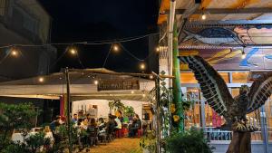 a group of people sitting at a restaurant at night at 那瑪夏Lu-Mah民宿 in Min-tsu