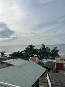 a group of roofs with the ocean in the background at Minh Duc Guesthouse in Phan Thiet