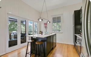 a kitchen with a large island in the middle of a room at Addisons Baroon A Rainforest Retreat with Heated Plunge pool in Montville