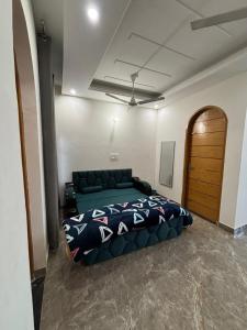a bedroom with a bed and a couch in it at shivoham Stays in Mājra +12 photos