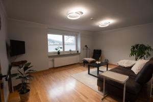 a living room with a couch and a window at Ferienwohnung Haus Mäsch in Wellen