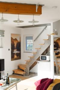 a living room with a staircase in a house at Vilka u Dyje in Znojmo +23 photos