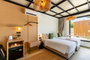 a bedroom with a large bed and a window at Nadi Glamping Suites, Auto-City in Perai