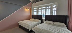 a bedroom with two beds and a window at A3-6-1Silverpark LuxMountsin view Lifted unit in Bukit Fraser