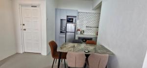 a kitchen with a table and chairs and a refrigerator at A3-6-1Silverpark LuxMountsin view Lifted unit in Bukit Fraser