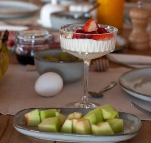 a dessert with fruit in a glass on a table at B&B Het Nagtegaaltje in Collendoorn +29 photos