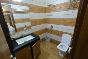 a bathroom with a sink and a toilet at Hotel Amar Singh Palace in Agra