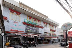 a group of motorcycles parked in front of a building at RedDoorz Plus near Simpang Tiga Tritayasa Cilegon in Cilegon