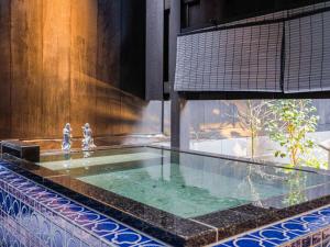 a swimming pool in the middle of a building at 椿とことは in Obama