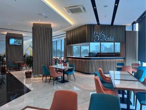 a restaurant with tables and chairs and a bar at 56 Hotel Block B in Kuching