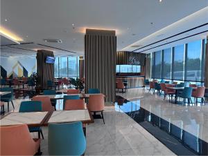 a restaurant with tables and chairs in a building at 56 Hotel Block B in Kuching