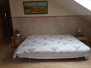 a bedroom with a bed and a brick wall at Apartment Laurence in Hanau am Main