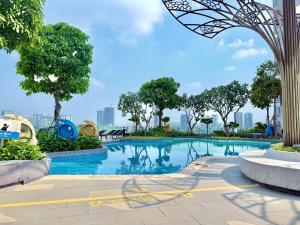 a large swimming pool with trees and buildings at The Sun Avenue - TPHomes in Ho Chi Minh City