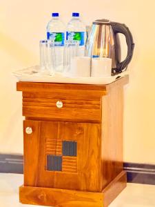 a table with bottles of water on top of it at Sigiriya On Rock Villa in Sigiriya